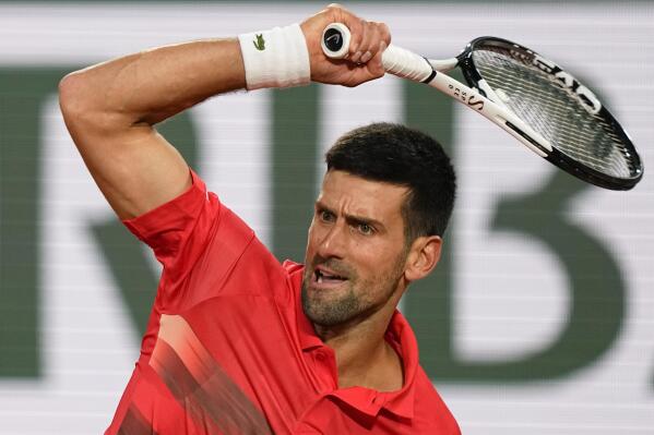 Serbia's Novak Djokovic plays a shot against Japan's Yoshihito Nishioka during their first round match at the French Open tennis tournament in Roland Garros stadium in Paris, France, Monday, May 23, 2022. (AP Photo/Michel Euler)
