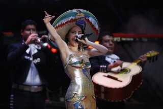 Mexican singer Belinda performs during the closing campaign rally for presidential candidate Andres Manuel Lopez Obrador, of the MORENA party, at Azteca stadium in Mexico City, Wednesday, June 27, 2018. Mexico's four presidential candidates are closing their campaigns before the country's July 1 elections. (AP Photo/Marco Ugarte)