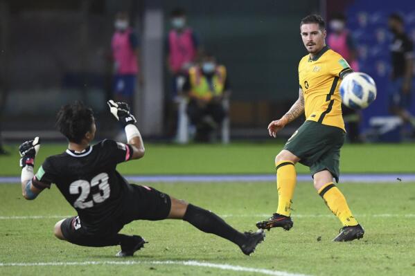 Australia's Jamie Maclaren shoots by Chinese Taipei's goalkeeper Shih Shin-An during the World Cup 2022 Group B qualifying soccer match between Chinese Taipei and Australia in Kuwait City, Kuwait, Monday, June 7, 2021. (AP Photo/Jaber Abdulkhaleg)
