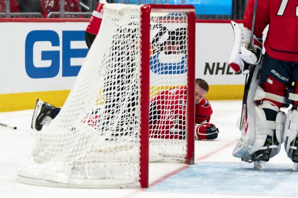 Washington Capitals center Evgeny Kuznetsov reacts after a hit to the head in the second period of an NHL hockey game against the Vegas Golden Knights, Tuesday, Nov. 14, 2023, in Washington. (AP Photo/Stephanie Scarbrough)