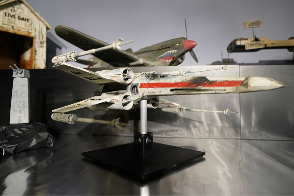 FILE - A miniature model called "Red Leader," a X-wing Starfighter from the 1977 film "Star War, Episode IV, A New Hope," sits on display at Heritage Auctions, Aug. 30, 2023, in Irving, Texas. The miniature X-wing Starfighter used in a “Star Wars” film sold for over $3 million on Sunday, Oct. 15, during a weekend auction of items both collected and created by longtime Hollywood model maker Greg Jein. (AP Photo/Tony Gutierrez, File)