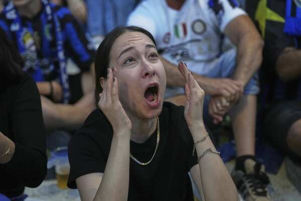 An Inter Milan fan reacts after PSG's Achraf Hakimi scored his side's opening goal during the Champions League final soccer match between Paris Saint-Germain and Inter Milan, in Milan, Italy, Saturday, May 31, 2025. (AP Photo/Antonio Calanni)