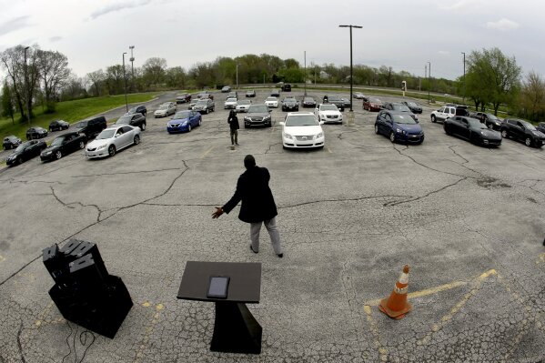FILE - In this April 12, 2020, file photo, Pastor W.R. Starr II preaches during a drive-in Easter Sunday service while churchgoers listen from their cars in the parking lot at Faith City Christian Center in Kansas City, Kan. The principle of religious freedom is important to most Americans. But as President Donald Trump touts his support for it during his reelection bid, there are notable fault lines among people of different faiths and political ideologies over what it truly means. (AP Photo/Charlie Riedel, File)