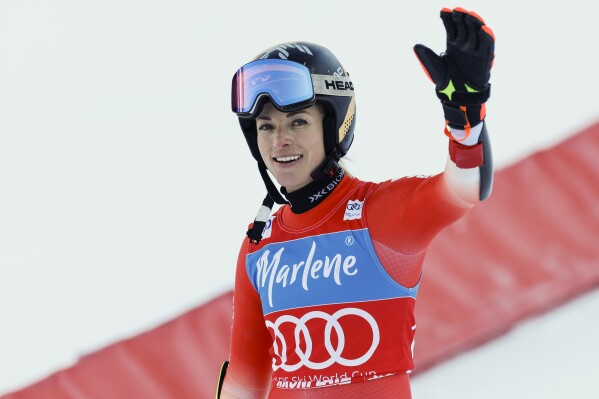 Switzerland's Lara Gut Behrami celebrates in the finish area after winning an alpine ski, women's World Cup giant slalom, in Kronplatz, Italy, Tuesday, Jan. 30, 2024. (AP Photo/Alessandro Trovati)