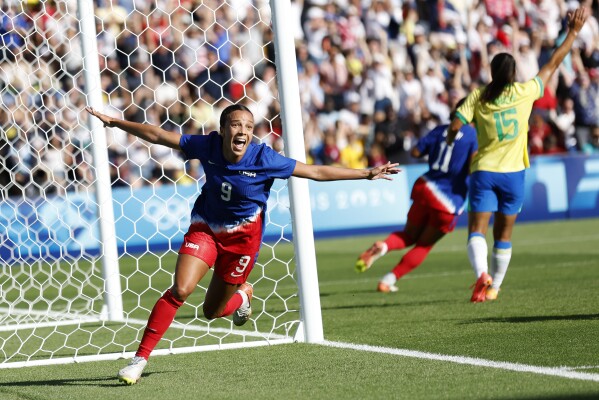 Mallory Swanson of the United States celebrates after scoring the opening goal during the women's soccer gold medal match between Brazil and the United States at the Parc des Princes during the 2024 Summer Olympics, Saturday, Aug. 10, 2024, in Paris, France. (AP Photo/Aurelien Morissard)