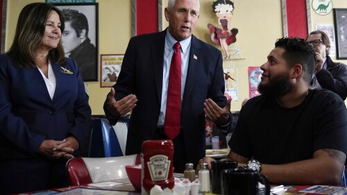 FILE - Republican presidential candidate former Vice President Mike Pence and his wife Karen, left, chat with a patrons during a campaign stop at a diner, June 9, 2023, in Derry, N.H. Weary Republicans who acknowledge Donald Trump's dominance, across New Hampshire are fighting to stop the former president from winning the first-in-the-nation primary. For now, however, they're relying on little more than hope and prayers. Look no further than Pence, who repeatedly appealed to voters' faith as he tried to resurrect his anemic presidential campaign while courting a few dozen voters in a former state lawmaker's backyard. (AP Photo/Charles Krupa, File)