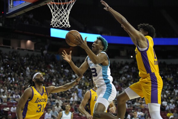 FILE - Charlotte Hornets' Kai Jones grabs a rebound against Los Angeles Lakers' Sacha Killeya-Jones, left, during the first half of an NBA summer league basketball game July 9, 2023, in Las Vegas. The Hornets announced Saturday, Sept. 30, that the 2021 first-round draft pick Jones will not participate in training camp due to personal reasons. (AP Photo/John Locher, File)