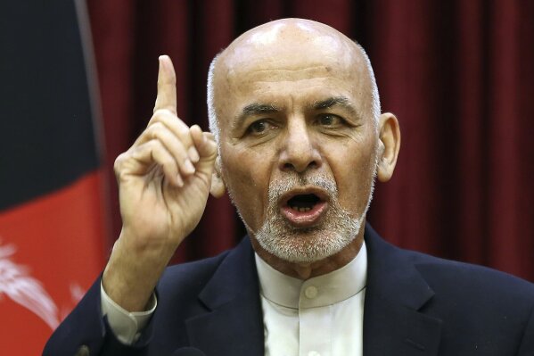 FILE - In this March, 1, 2020, file photo, Afghan President Ashraf Ghani speaks during a news conference in presidential palace in Kabul, Afghanistan. Squabbling Afghan presidential rivals threatened to declare themselves president in dueling ceremonies Monday, March 9, 2020, throwing plans for intra-Afghan negotiations into chaos. (AP Photo/Rahmat Gul, File)