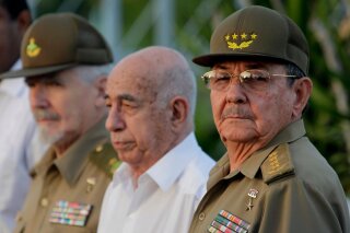FILE - In this July 26, 2009 file photo, Cuba's authorities, from right, President Raul Castro, Vice-President Jose Ramon Machado Ventura and Revolutionary Commander Ramiro Valdes attend a rally marking Cuba's Day of National Rebellion in Holguin, Cuba. Castro, Machado and Valdez are some of the main government figures in the Cuban establishment preparing to usher in new leadership in 2018. (AP Photo/Javier Galeano, Pool, File)