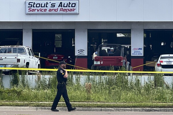 Law enforcement investigate the scene of a shooting, Wednesday, Sept. 27, 2023 in Largo, Fla. At least two people were wounded Wednesday in a shooting at a Florida auto shop that drew dozens of police officers to the scene, authorities said. (Douglas R. Clifford/Tampa Bay Times via AP)