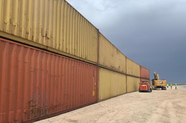FILE - This photo provided by the Arizona Governor's Office shows shipping containers that will be used to fill a 1,000 foot gap in the border wall with Mexico near Yuma, Ariz., on Aug. 12, 2022. The Cocopah Indian Tribe said Friday, Sept. 2, that the state of Arizona acted against its wishes by stacking shipping containers on its land to prevent illegal border crossings.  (Arizona Governor's Office via AP, File)
