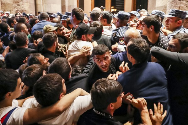 Demonstrators clash with police at the Armenia government building to protest against Prime Minister Nikol Pashinyan, Tuesday, Sept. 19, 2023, in Yerevan, Armenia. (Vahram Baghdasaryan/Photolure via AP)