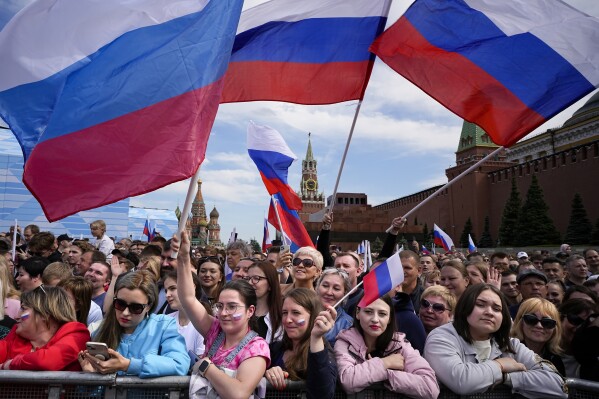 FILE - Thousands of people wave Russian national flags as they gather on Red Square to watch a concert dedicated to the Day of Russia in Moscow, Russia, Sunday, June 11, 2023. (AP Photo/Alexander Zemlianichenko, File)