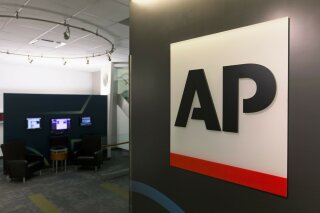 FILE - This Tuesday, April 26, 2016 file photo shows The Associated Press logo in New York. The Associated Press has pulled out of its planned coverage of Wednesday's CMA Awards show due to a dispute over photographs of the broadcast.  (AP Photo/Hiro Komae, File)