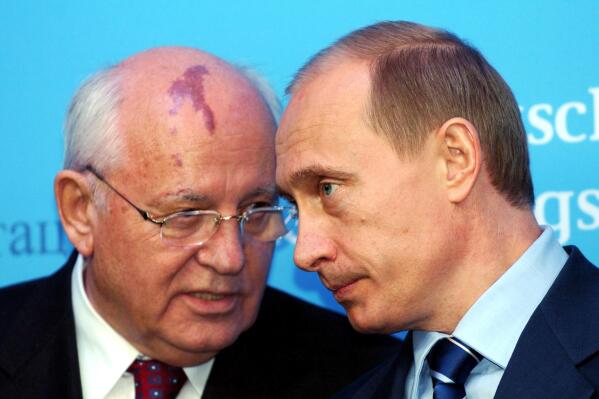 FILE - Russia's President Vladimir Putin, right, talks with former Soviet President Mikhail Gorbachev at the start of a news conference at the Castle of Gottorf in Schleswig, northern Germany, Tuesday, Dec. 21, 2004. One stood for freedom, openness, peace and closer ties with the outside world. The other is jailing critics, muzzling journalists, pushing his country deeper into isolation and waging Europe's bloodiest conflict since World War II. Such are history's bookends between Mikhail Gorbachev, the last leader of the Soviet Union, and Vladimir Putin, president of Russia. (Carsten Rehder/dpa via AP, File)