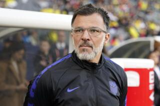 United States head coach Anthony Hudson stands near the bench before an international friendly soccer match against Colombia Saturday, Jan. 28, 2023, in Carson, Calif. Hudson quit as interim head coach of the U.S. men's soccer team on Tuesday, May 30, 2023. just two weeks before he was to lead the Americans in the CONCACAF Nations League semifinals. He was replaced by B.J. Callaghan, another holdover from Gregg Berhalter's former staff. (AP Photo/Marcio Jose Sanchez, File)