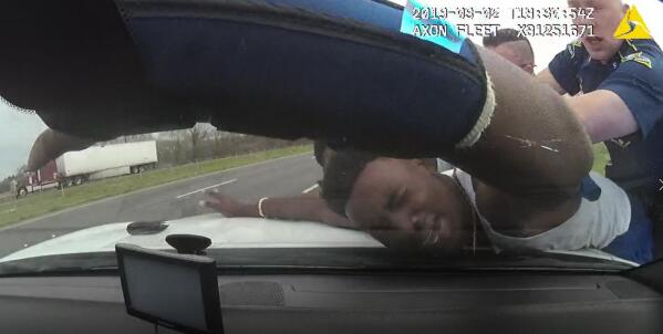 In this March 2, 2019 image from police dashboard camera video obtained by The Associated Press, Louisiana State Trooper Jacob Brown slams motorist DeShawn Washington against the hood of a police cruiser during a traffic stop in Ouachita Parish, La., after troopers found marijuana in the trunk of Washington's car. (Louisiana State Police via AP)