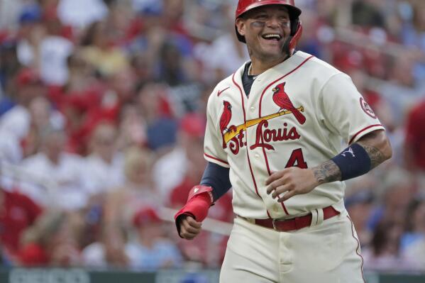 St. Louis Cardinals catcher Yadier Molina smiles while looking toward Kansas City Royals catcher Salvador Perez as Molina heads back to the dugout between the first and second innings of a baseball game Saturday, Aug. 7, 2021, in St. Louis. (AP Photo/Tom Gannam)