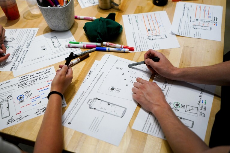 Starbucks employees discuss personal cup designs in a focus group at the Tryer Center at Starbucks headquarters, Wednesday, June 28, 2023, in Seattle. (AP Photo/Lindsey Wasson)
