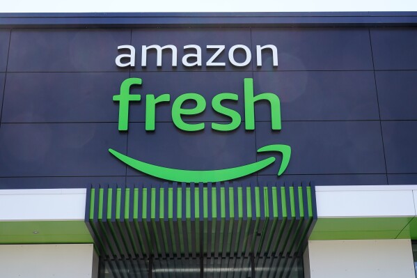 FILE - An Amazon Fresh grocery store in Warrington, Pa., April 28, 2022. Amazon has begun offering its Fresh grocery delivery service to customers who aren’t Prime members. The initial rollout will only be available in a dozen cities, including Boston, Phoenix, Dallas and San Francisco, the company told customers Wednesday, Aug. 2, 2023, in an emailed announcement. (AP Photo/Matt Rourke, File)