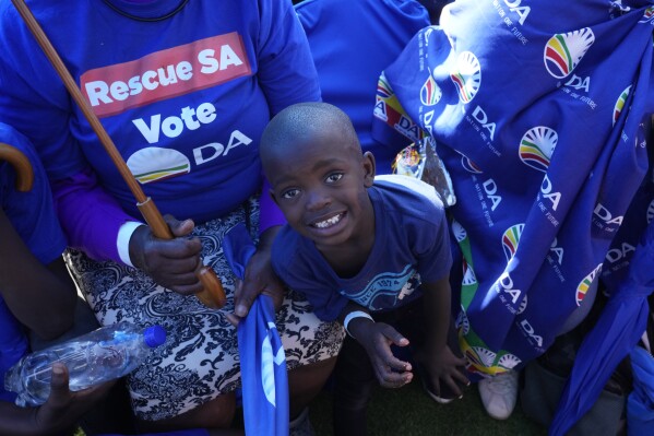 Supporters of the main opposition Democratic Alliance (DA) party attend a final election rally in Benoni, South Africa, Sunday, May 26, 2024. South Africa's four main political parties began the final weekend of campaigning Saturday before a possibly pivotal election that could bring the country's most important change in three decades. (AP Photo/Themba Hadebe)