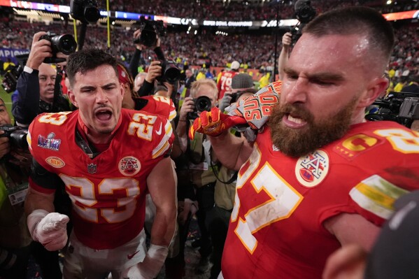 Kansas City Chiefs tight end Travis Kelce (87) and Kansas City Chiefs linebacker Drue Tranquill (23) celebrate after the NFL Super Bowl 58 football game against the San Francisco 49ers on Sunday, Feb. 11, 2024, in Las Vegas. The Kansas City Chiefs won 25-22 against the San Francisco 49ers. (APPhoto/Ashley Landis)