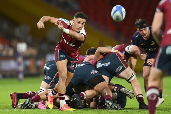 Kalani Thomas of the Queensland Reds passes the ball during their Super Rugby Pacific game against the Highlanders at Suncorp Stadium in Brisbane, Australia, Friday, April 19, 2024. (Darren England/AAP Image via AP)