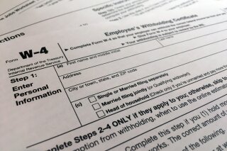 FILE - In this Feb. 5, 2020, file photo, a W-4 form is viewed in New York. As the coronavirus pandemic took hold this spring, the federal government postponed the traditional April 15 filing deadline until July 15. The move provided some economic and logistic relief for taxpayers dealing with the disruptions and uncertainty brought on by lockdowns, school closures and shuttered businesses. But now that new deadline is rapidly approaching. (AP Photo/Patrick Sison, File)
