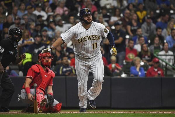 Milwaukee Brewers' Rowdy Tellez, right, watches his home run during the second inning of a baseball game against the Cincinnati Reds, Sunday, Sept. 11, 2022, in Milwaukee. (AP Photo/Kenny Yoo)