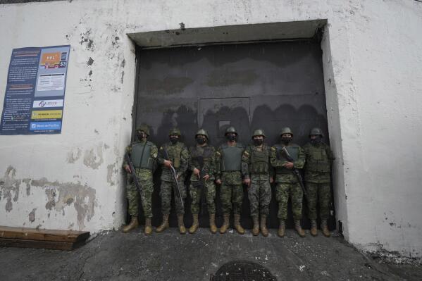 Soldiers guard an entrance to the Inca jail where eight inmates were killed during a prison riot, according to Police Commander Victor Herrera, in Quito, Ecuador, Friday, Nov. 18, 2022.  (AP Photo/Dolores Ochoa)