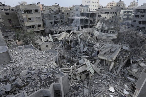 Palestinians inspect the rubble of the Yassin Mosque, destroyed after it was hit by an Israeli airstrike at Shati refugee camp in Gaza City, early Monday, Oct. 9, 2023. (AP Photo/Adel Hana)