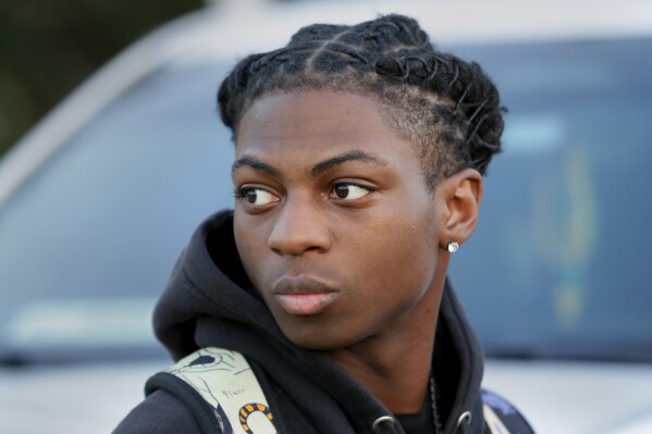 FILE - Darryl George, a 17-year-old junior, before walking across the street to go into Barbers Hill High School after serving a 5-day in-school suspension for not cutting his hair, Sept. 18, 2023, in Mont Belvieu, Texas. A trial is set to be held Thursday, Feb. 21, 2024, to determine if George can continue being punished by his district for refusing to change his hairstyle, which he and his family say is protected by a new state law that prohibits race-based hair discrimination. (APPhoto/Michael Wyke, File)