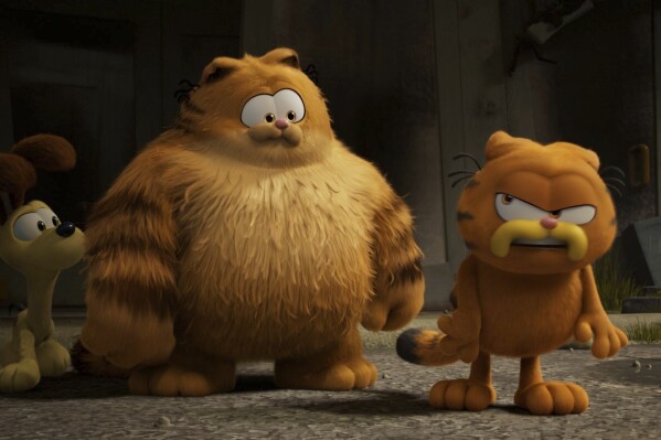 This image released by Sony Pictures shows characters Odie, voiced by Harvey Guillén, from left, Vic, voiced by Samuel L. Jackson, and Garfield, voiced by Chris Pratt, in a scene from the animated film "The Garfield Movie." (Columbia Pictures/Sony via AP)