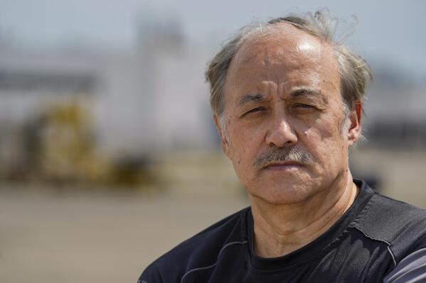 Dave Muffley poses outside one of the Delphi Corporation plants in Kokomo, Ind., Monday, July 11, 2022. As General Motors Corp. underwent the biggest industrial bankruptcy proceedings in history, and the federal government negotiated a company restructuring, Muffley's healthy retirement savings would be slashed by 70 percent, and his life's trajectory would take a dramatic spiral downward. (AP Photo/Michael Conroy)