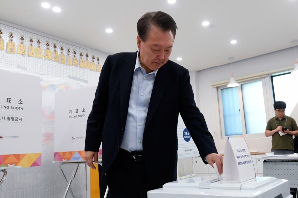 Former South Korean President Yoon Suk Yeol casts his vote for the presidential election at a polling station in Seoul, South Korea, Tuesday, June 3, 2025. (Korea Pool/Yonhap via AP)