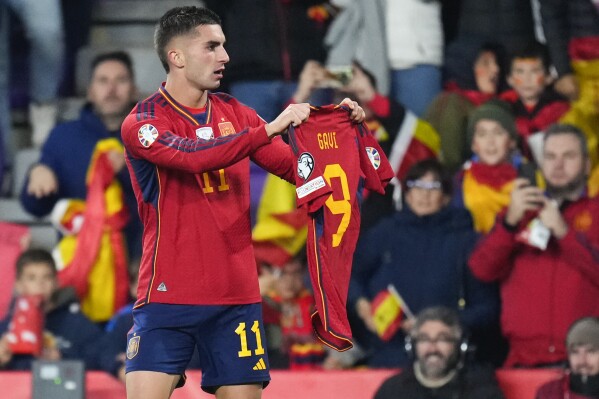 Spain's Ferran Torres holds up teammate Gavi Paez's shirt after scoring his team's second goal during the Euro 2024 group A qualifying soccer match between Spain and Georgia at Jose Zorrilla Stadium in Valladolid, Spain, Sunday, Nov. 19, 2023. (AP Photo/Manu Fernandez)