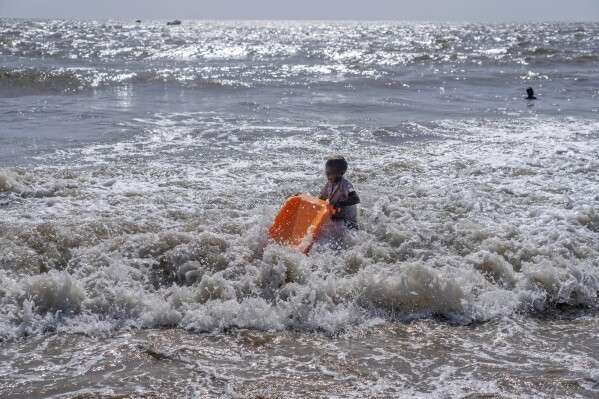 A boy plays in the Arabian Sea on a hot summer day in Mumbai, India, Thursday, May 2, 2024. (Ǻ Photo/Rafiq Maqbool)