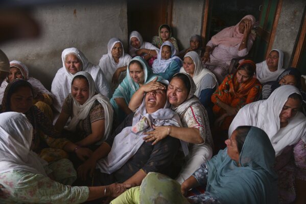 Jabir Kaur, wife of Sukhwinder Singh, center, wails after her husband died consuming toxic liquor, in Majitha village on the outskirts of Amritsar, India, Tuesday, May 13, 2025. (AP Photo/Prabhjot Gill)