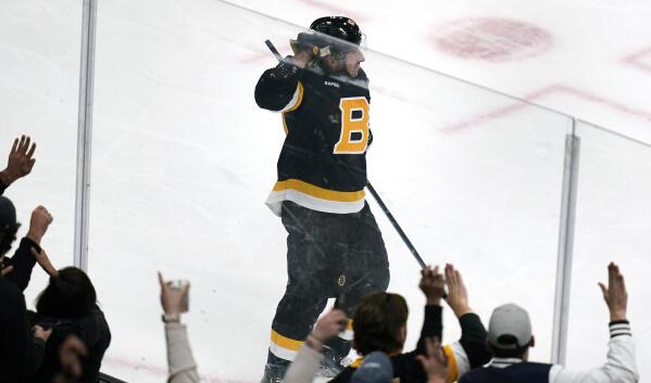 Boston Bruins center Brad Marchand, left, celebrates with