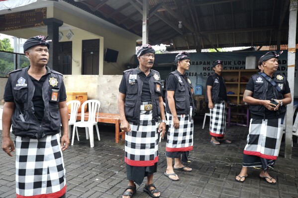 Balinese traditional guards called "pecalang" patrol keep guard to enforce restrictions on Nyepi, or Day of Silence, in Bali, Indonesia on Monday, March 11, 2024. Airports closed for 24 hours, the internet was turned off and streets were empty as the predominantly Hindu island of Bali in Muslim-majority Indonesia marked its New Year with an annual Day of Silence, part of six days of extensive New Year rituals. (AP Photo/Firdia Lisnawati)