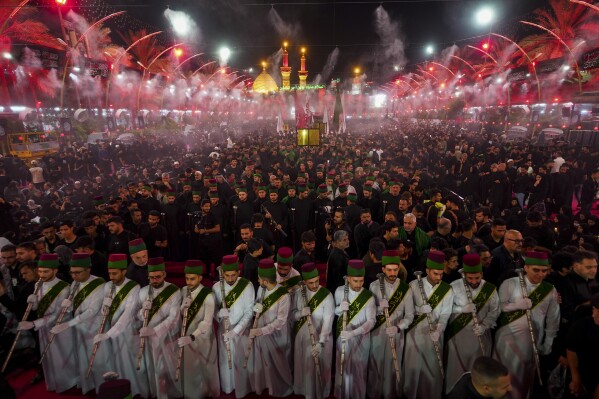 Shiites participate in the Ashoura procession on the 9th day of Muharram in Karbala, Iraq, Friday, July 28, 2023. In the Middle East and North Africa, where religion is often ingrained in daily life's very fabric, rejecting faith can come with social or other repercussions, so many of the "nones," a group that includes agnostics, atheists and "nothing in particular" conceal that part of themselves, as blasphemy laws and policies are widespread in the region. (AP Photo/Anmar Khalil)
