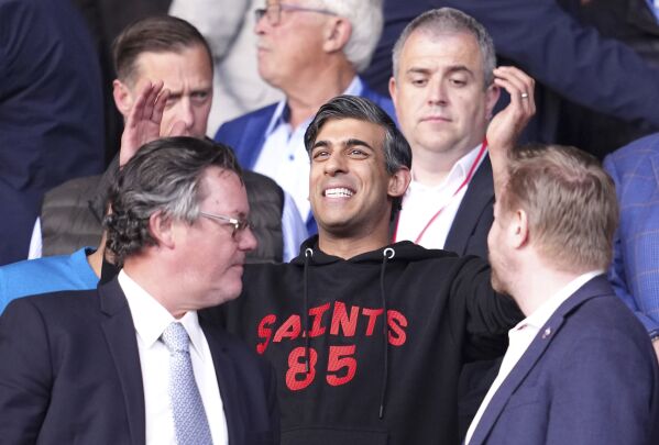 Britain's Prime Minister Rishi Sunak gestures in the stands during the Sky Bet Championship play-off, semi-final, second leg match between West Bromwich Albion and Southampton at St Mary's Stadium in Southampton, Friday May 17, 2024. (Adam Davy/PA via AP)
