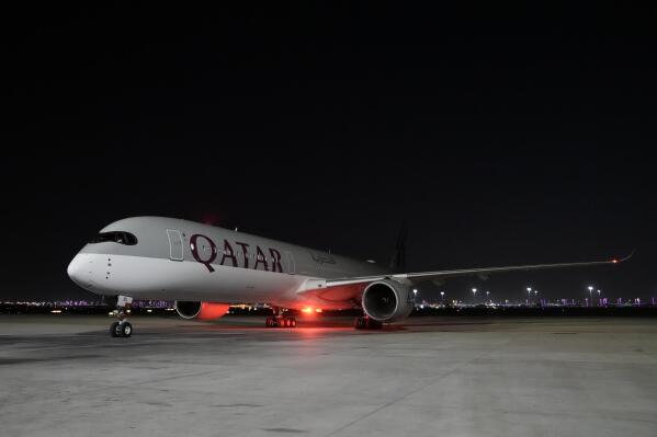A Qatar Airways aircraft lands with members of the United States national soccer team at Hamad International airport in Doha, Qatar, Thursday, Nov. 10, 2022 ahead of the upcoming World Cup. The US will play their first match in the World Cup against Wales on Nov. 21. (AP Photo/Hassan Ammar)