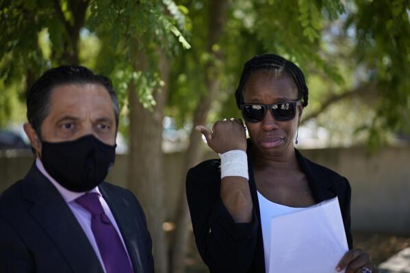 Lawyer Javier Villalba, left and John McAfee's wife Janice speak briefly with journalists on leaving the Brians 2 penitentiary center in Sant Esteve Sesrovires, near Barcelona, northeast Spain, Friday, June 25, 2021. A judge in northeastern Spain has ordered an autopsy for John McAfee, creator of the McAfee antivirus software, a gun-loving antivirus pioneer, cryptocurrency promoter and occasional politician who died in a cell pending extradition to the United States for allegedly evading millions in unpaid taxes. McAfee's Spanish lawyer, Javier Villalba, said the entrepreneur's death had come as a surprise to his wife and other relatives, since McAfee "had not said goodbye." (AP Photo/Joan Mateu)