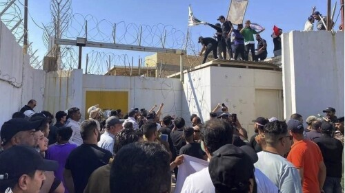 In this photo provided by the Iraqi News Agency, followers of the influential Iraqi Shiite cleric and political leader Muqtada Sadr storm the Swedish embassy in Baghdad, Iraq, Thursday, June 29, 2023, in protest of the burning of a Quran in Sweden. An Iraqi security official has said the Swedish embassy was evacuated by security forces after the protesters breached the building. (Iraqi News Agency via AP)