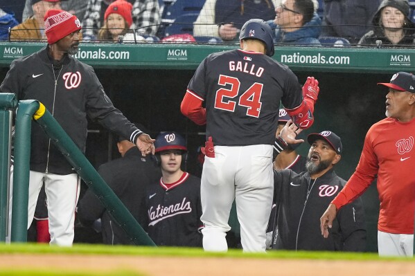 Washington Nationals' Joey Gallo celebrates his solo home run with manager Dave Martinez, bottom right, during the second inning of a baseball game against the Pittsburgh Pirates, at Nationals Park, Wednesday, April 3, 2024, in Washington. (AP Photo/Alex Brandon)