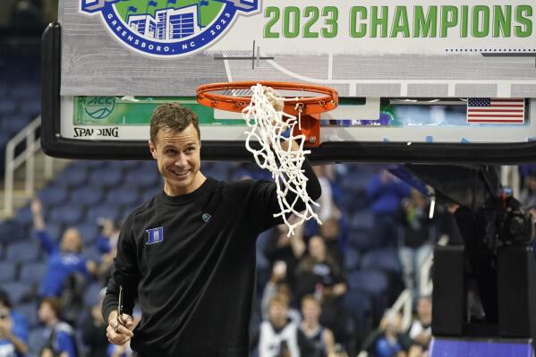 Duke head coach Jon Scheyer waves the net after Duke's win over Virginia in an NCAA college basketball game for the championship of the Atlantic Coast Conference tournament in Greensboro, N.C., Saturday, March 11, 2023. (AP Photo/Chuck Burton)