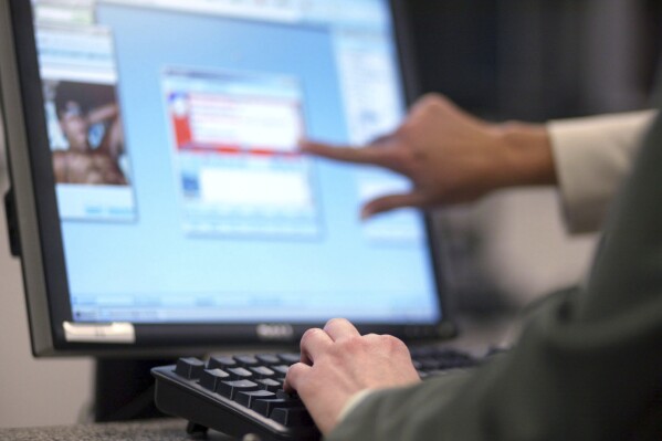 FILE - FBI Supervisory Special Agent Stacey Bradley and Special Agent "Jackie" of the Innocent Images Unit monitors possible child pornography offenders on May 4, 2006 in Calverton, Md. in an online chat room. European Union lawmakers adopted Tuesday, Nov. 14, 2023, a series of proposals to amend a bill from the EU’s executive arm to fight online child pornography as they tried to find the right balance between protecting children and protecting privacy. (AP Photo/Matt Houston)