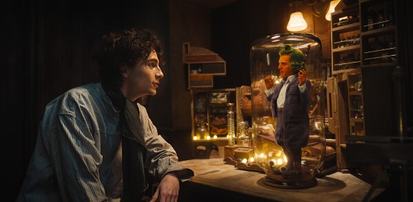 This image released by Warner Bros. Pictures shows Timothee Chalamet, left, and Hugh Grant in a scene from "Wonka." (Warner Bros. Pictures via AP)