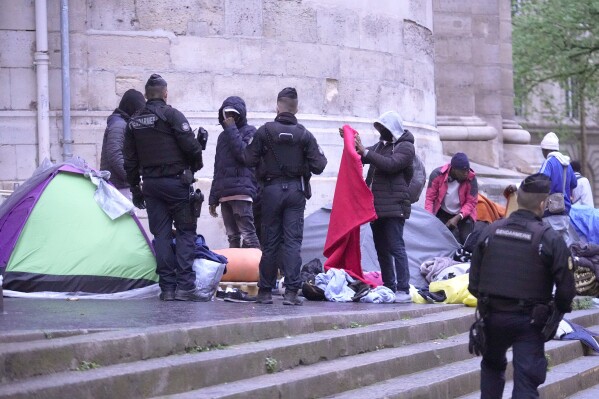 Miigrants are being evicted from a makeshift camp, Tuesday, April 30, 2024 in Paris. Similar operations are carried out by the police authorities on a daily basis in the months leading to the Olympics. (AP Photo/Michel Euler)